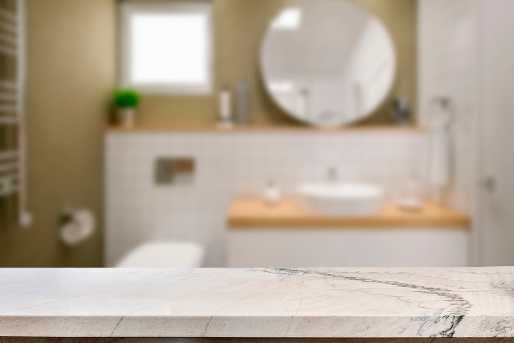 A sleek marble countertop in a bathroom, elegantly paired with a white toilet, creating a modern and clean aesthetic.