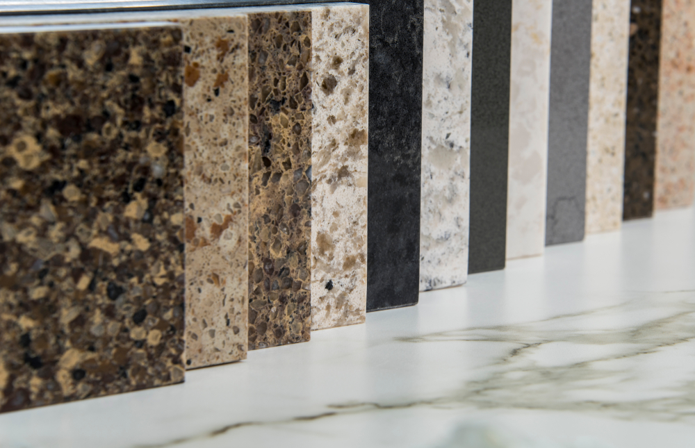 Different types of granite countertops and marble lined up, displaying a range of colors and patterns.